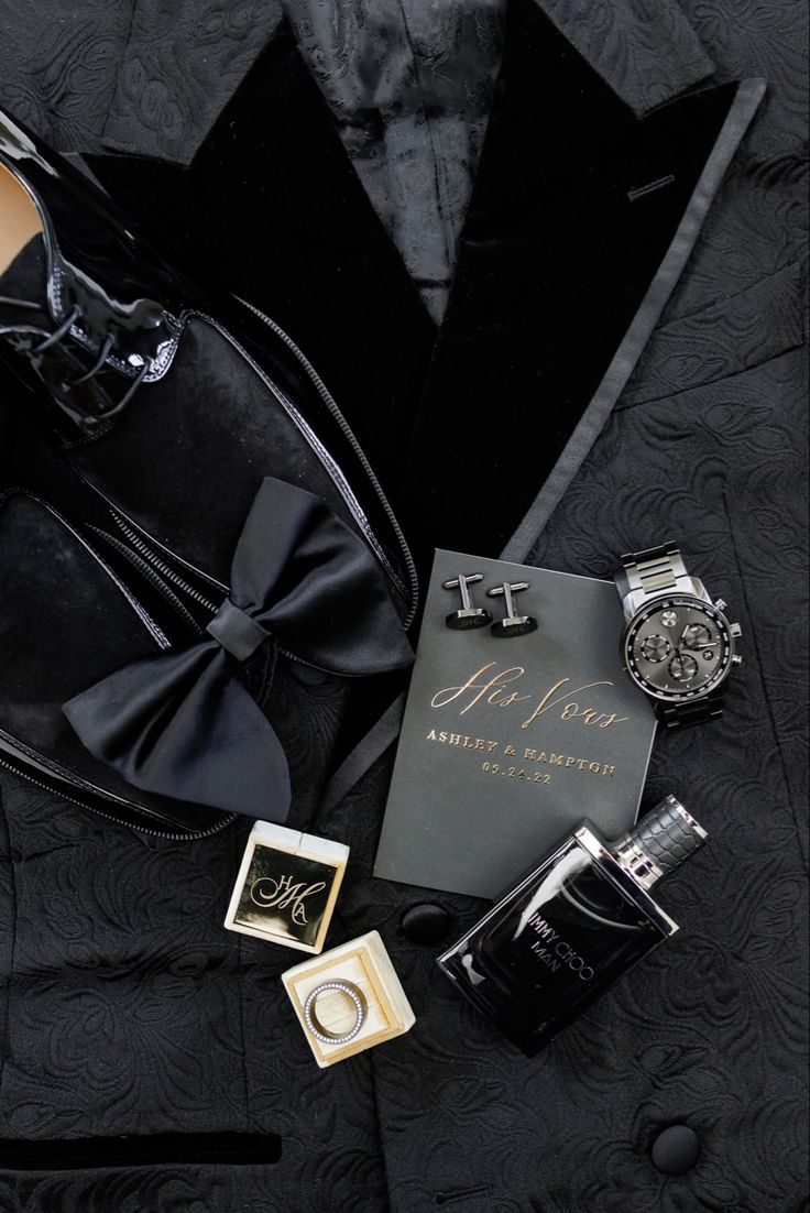 an assortment of men's accessories including a watch, tie, and perfume bottle