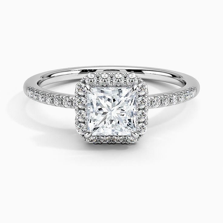 an engagement ring with a square cut diamond surrounded by pave diamonds