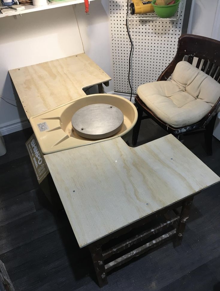 two chairs sitting next to each other in front of a table with a bowl on it