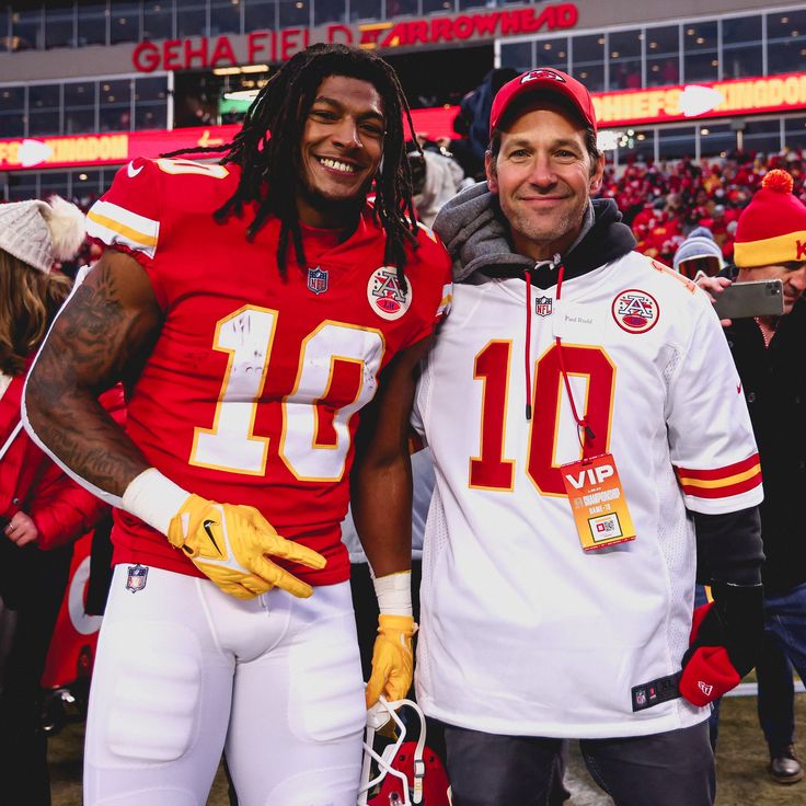 two football players standing next to each other