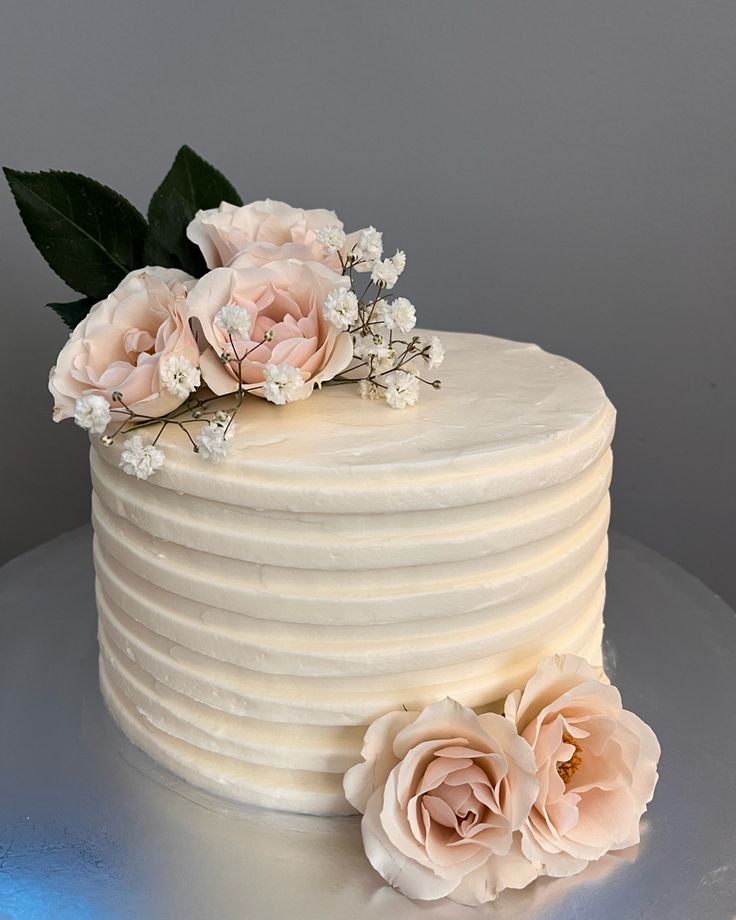 there is a white cake with flowers on top