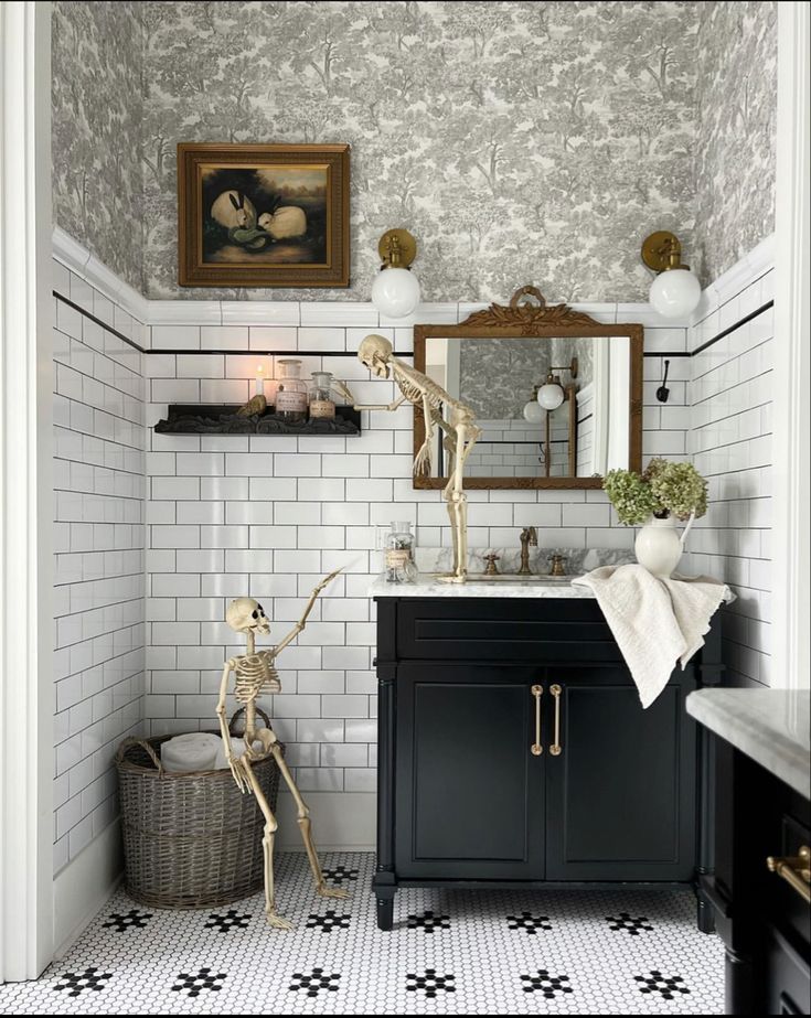 the bathroom is decorated in black and white with a skeleton statue on the sink counter