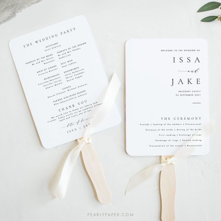 two wedding programs with ribbons tied around them