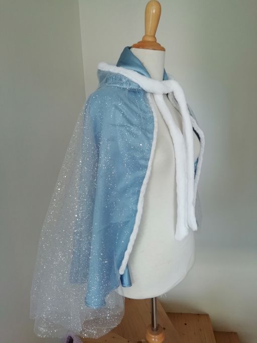 a mannequin wearing a blue and white jacket with sequins on it