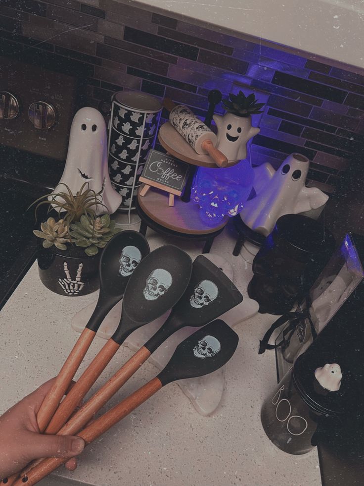 a counter topped with lots of halloween themed utensils