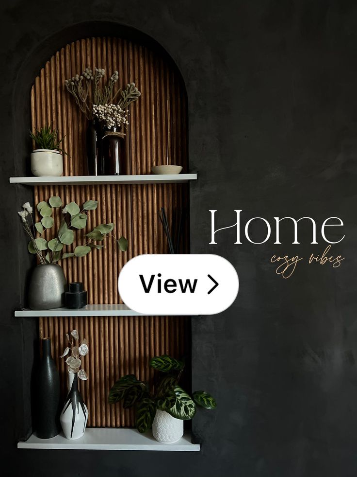 a shelf with vases and plants on it in front of a wall that says home