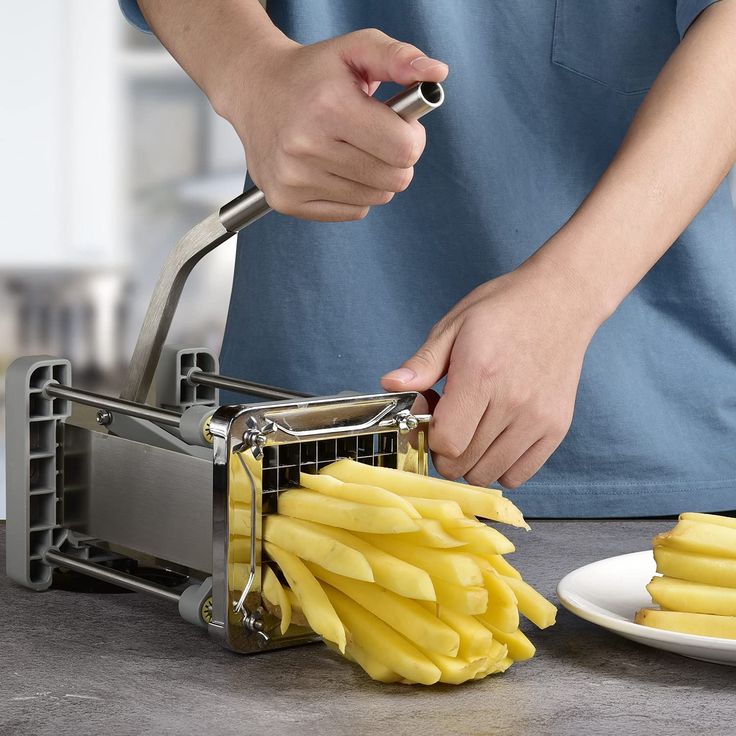 a person is cutting up some food with a slicer on the table next to it