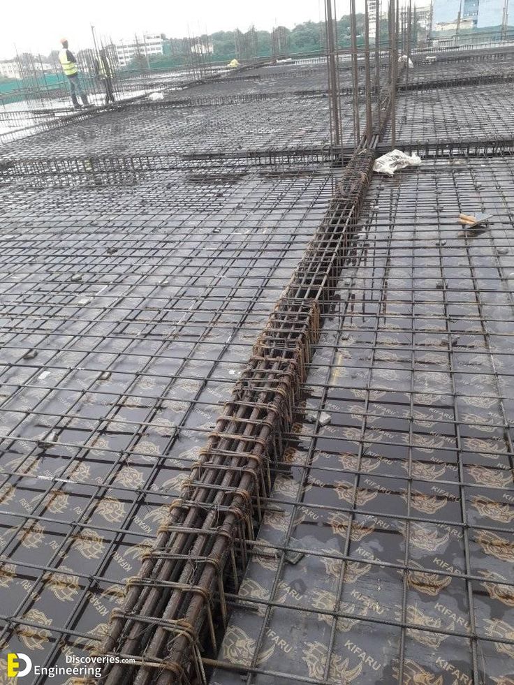 the floor is covered with concrete and steel grates for pouring water into the pool