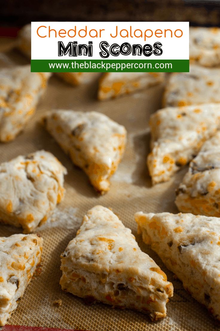 cheddar jalapeno mini scones are sitting on a baking sheet