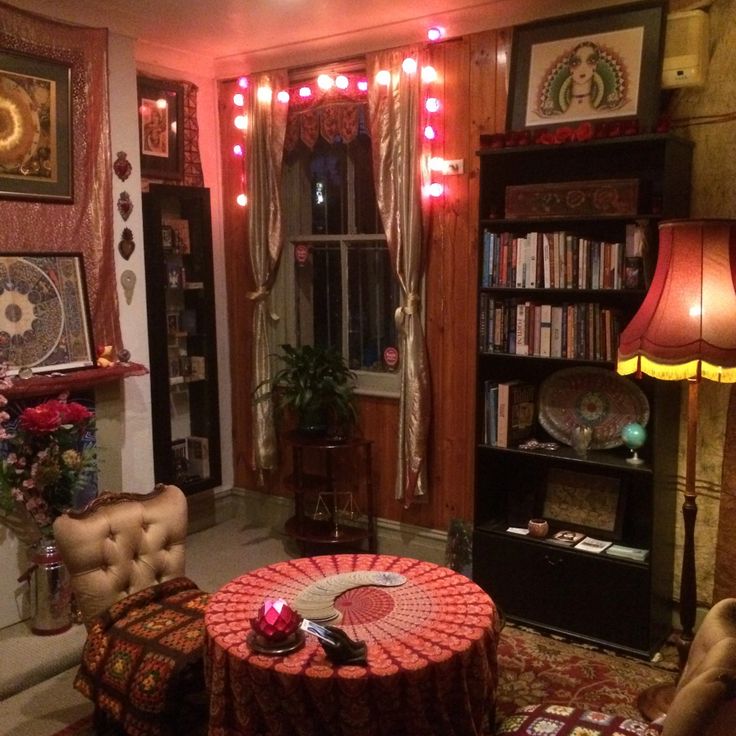 a living room filled with furniture and a fire place next to a book shelf full of books