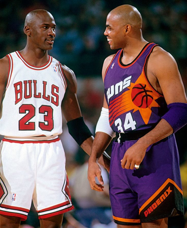 two basketball players standing next to each other