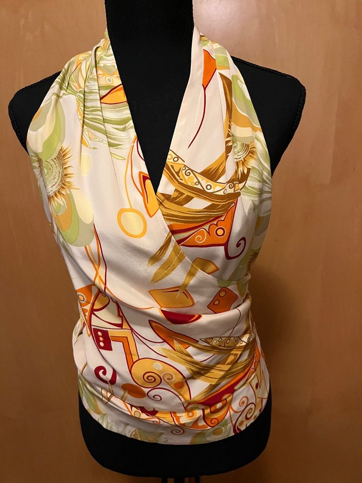 Lafayette 148 100 % silk, white with multi-colored abstract citrus colors, (orange, lemon, lime) sleeveless halter wrap blouse Fitted Multicolor V-neck Halter Top, Fitted Sleeveless Blouse Halter Top For Vacation, Fitted Sleeveless Halter Top For Vacation, Fitted Summer Sleeveless Halter Top, Elegant Silk Halter Top For Summer, Chic Printed Sleeveless Halter Top, Elegant Summer Halter Top, Elegant Halter Neck Blouse For Beach, Yellow Floral Print Silk Tops