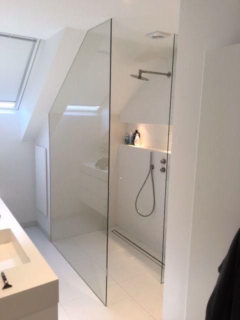 a bathroom with a shower, sink and mirror