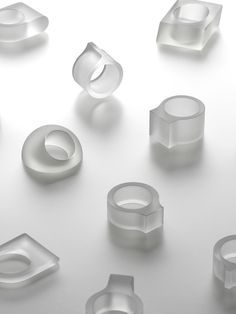 many different shapes and sizes of rings on a white surface