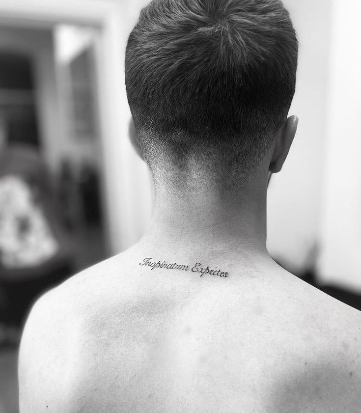 the back of a man's neck with an inscription on it