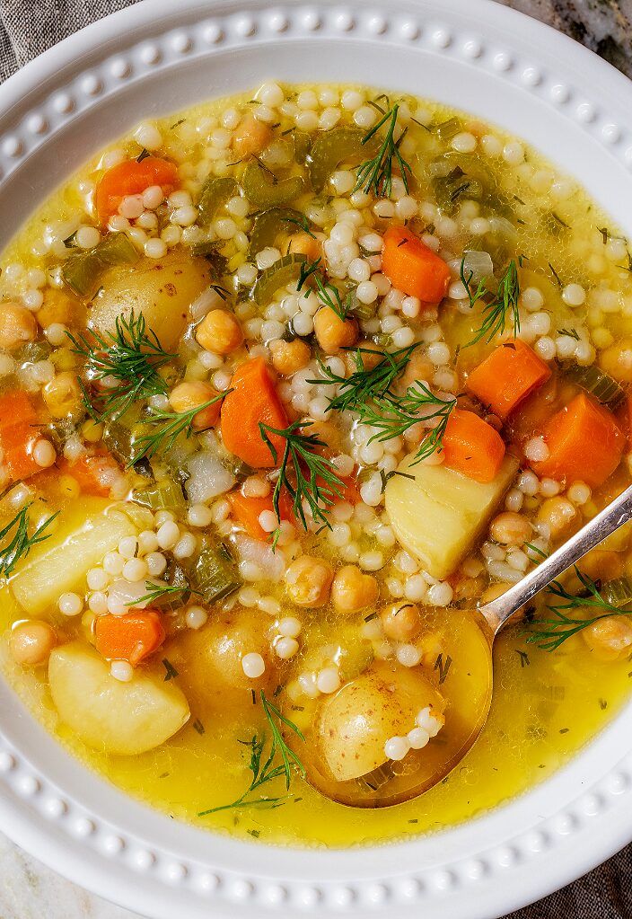 a white bowl filled with soup and vegetables