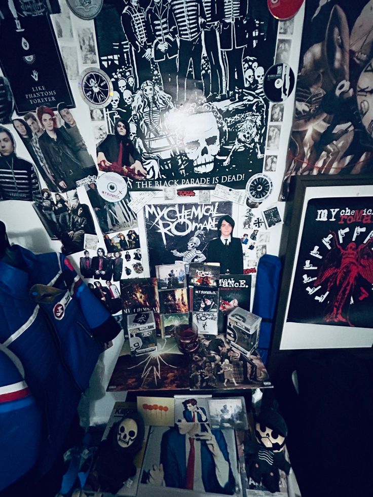 a room filled with lots of posters and pictures on the wall next to a bed