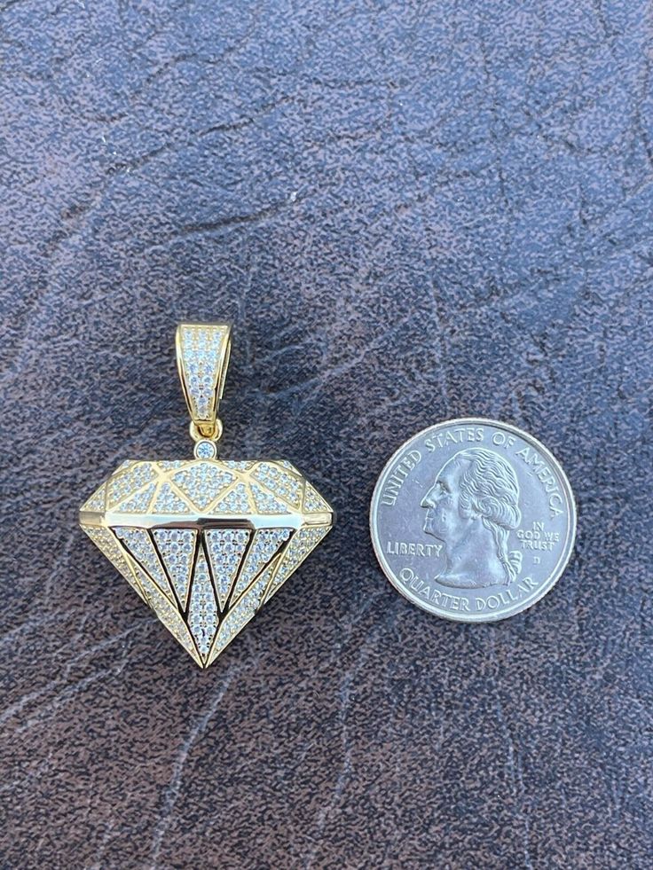 "Hip Hop Diamond shape bling pendant Super detailed Solid 925 Sterling Silver Natural silver of finished in 14k yellow gold Will never turn green! SOLID SILVER...Great investment! Micropaved with simulated diamonds (CZ) Weighs about 8.5 grams About 1.25\" by 1.25\" (1.5\" w bale) Nice medium size...very visible yet not too gaudy Fits most chains up to 6mm thick You can buy pendant only or with our 2mm rope chain Our chain is also 925 silver made in Italy and stamped 925" Gold Round Pendant With Prong Setting, Gold Pendant Jewelry With Prong Setting, Gold Pendant With Prong Setting, Silver Jewelry With Diamond Markers Round Cut, Yellow Gold Jewelry With Diamond Markers For Gift, Anniversary White Gold Jewelry With Diamond Markers, Gold Jewelry With Diamond Markers In 14k Gold, Gold Jewelry With Diamond Markers As Gift, White Gold Jewelry With Diamond Markers For Gift