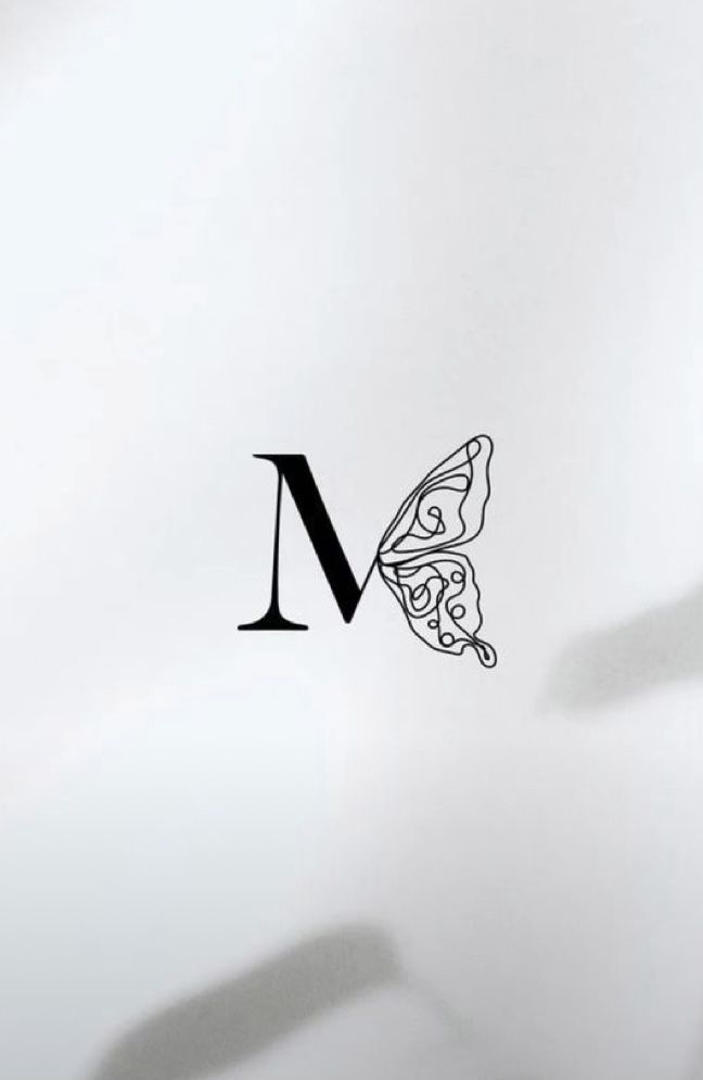 the letter m with a butterfly on it's back side is shown in black and white