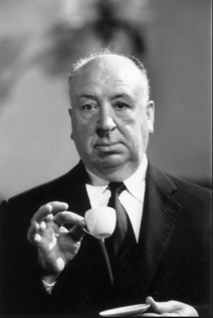 a man in a suit holding a small white object