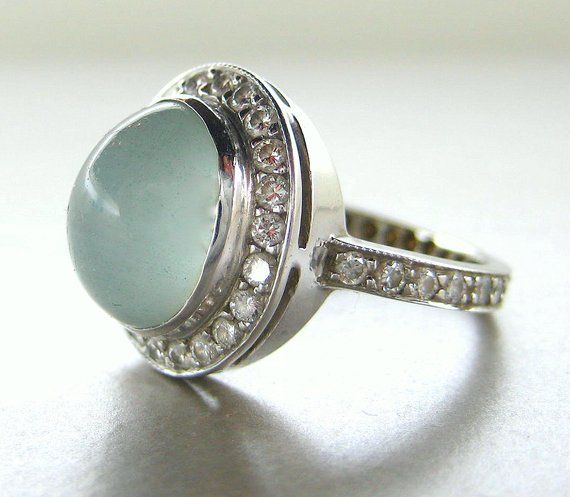 Milky aquamarine ring. Aquamarine diamond ring. Milky aquamarine engagement ring. 14k white gold with milky aquamarine. Beautiful ring, 14k white gold band with diamonds all around the band.  The center stone is a cabochon milky aquamarine.   You will get so many compliments on this ring.This ring is perfect as an engagement ring, birthday, anniversary!!I can replace the center stone with any other cabochon stone.  Please contact me for a quote.Measurements:Milky aquamarine: 15mmx9mm 3.94 ct  (w Elegant Light Blue Aquamarine Diamond Ring, Elegant Light Blue Diamond Ring, Elegant White Aquamarine Rings, Elegant Blue Moonstone Ring For Formal Occasions, Luxury Blue Moonstone Wedding Ring, Elegant Moonstone Ring With Aquamarine Gemstone, Modern Aquamarine Ring For Wedding, Modern Aquamarine Wedding Ring, Gold Band With Diamonds