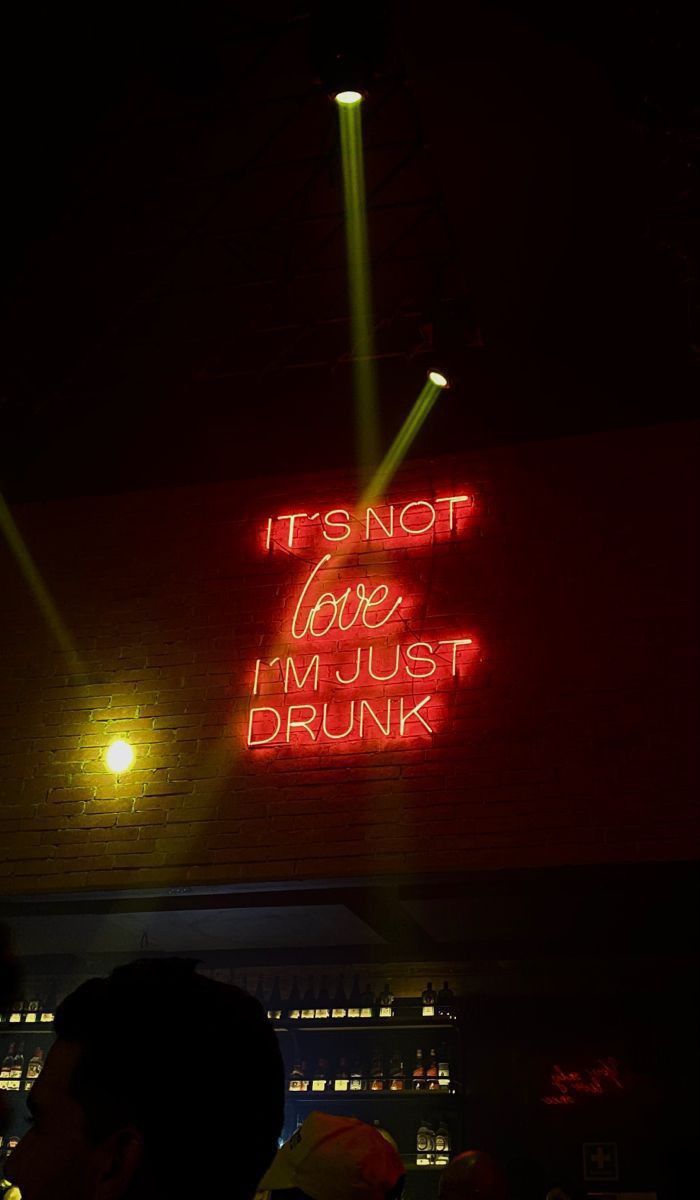 a neon sign that says it's not love i'm just drunk