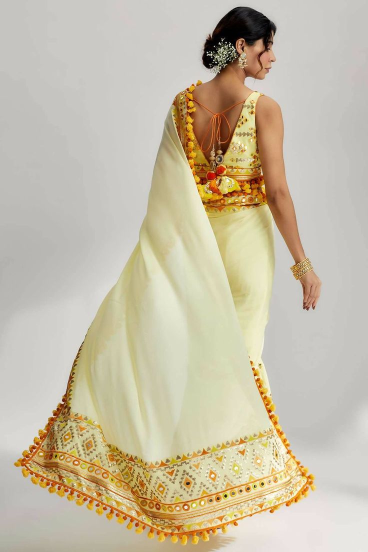 Transitional Raw Silk Pre-draped Saree With Gota Work, Transitional Art Silk Saree With Mirror Work, Festive Eid Pre-draped Saree With Mirror Work, Festive Yellow Pre-draped Saree With Mirror Work, Transitional Dola Silk Saree With Mirror Work, Pre-draped Saree With Mirror Work For Celebration, Transitional Pre-draped Saree With Gota Work, Transitional Season Pre-draped Saree With Gota Work, Bohemian Sharara With Mirror Work For Eid