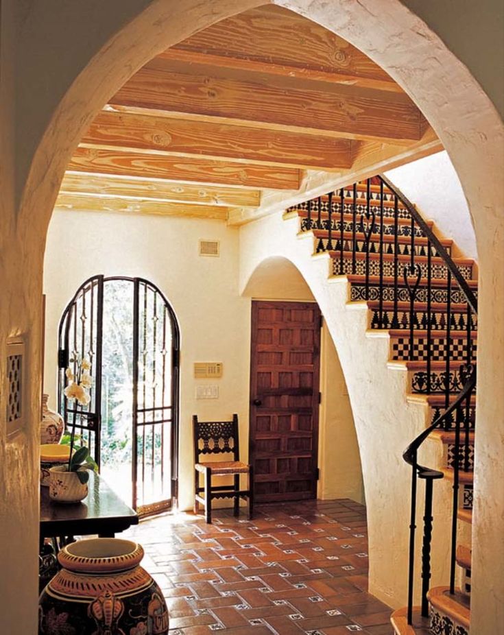 an arched entry way leading to a dining room