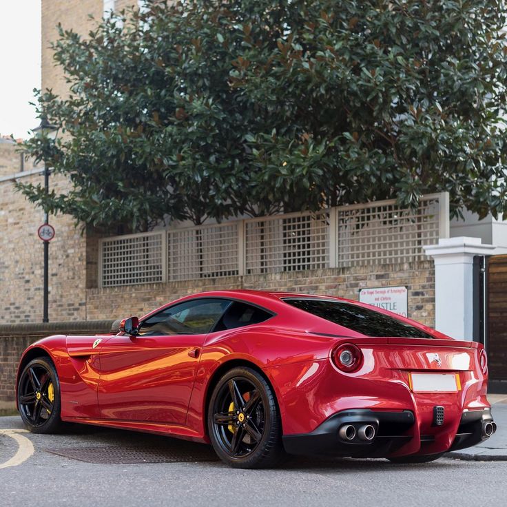 a red sports car parked in front of a building