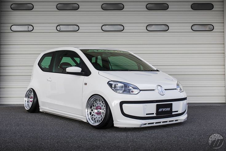 a white car parked in front of a garage door