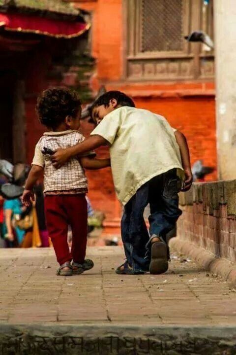 two children hugging each other on the street with a caption that reads, we rise by lifting others robert ingersoll