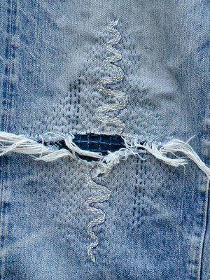 an old pair of jeans with holes in it