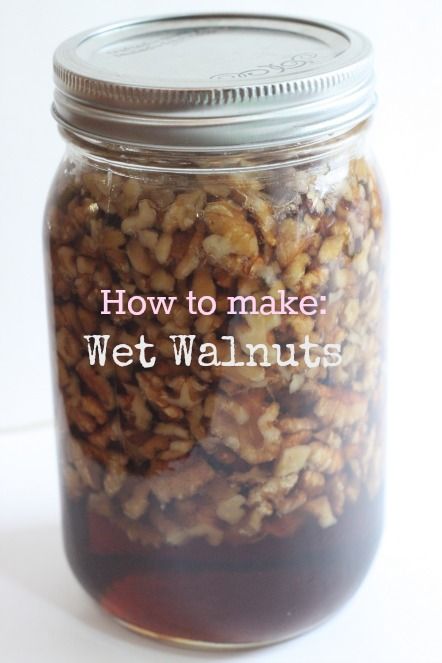 a jar filled with walnuts sitting on top of a table