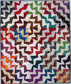 a quilt made with different colors and shapes