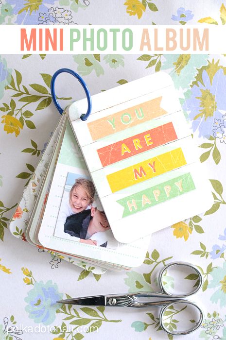 a mini photo album with a pair of scissors next to it and the words you are my happy