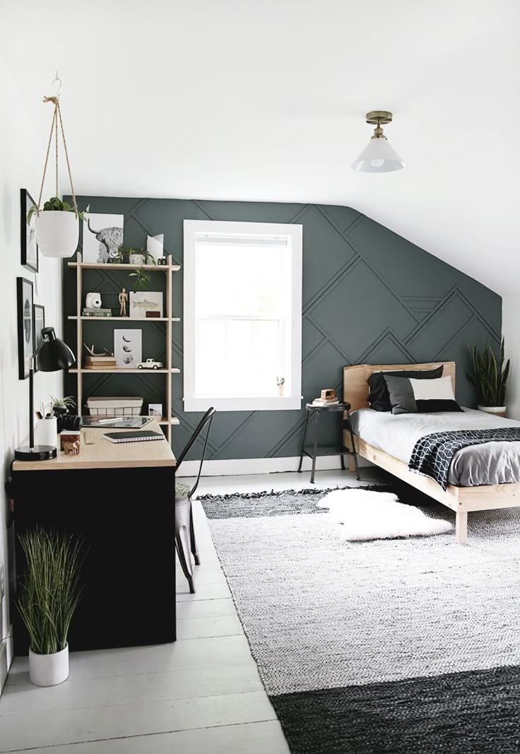 a bedroom with a bed, desk and bookshelf on the wall next to it