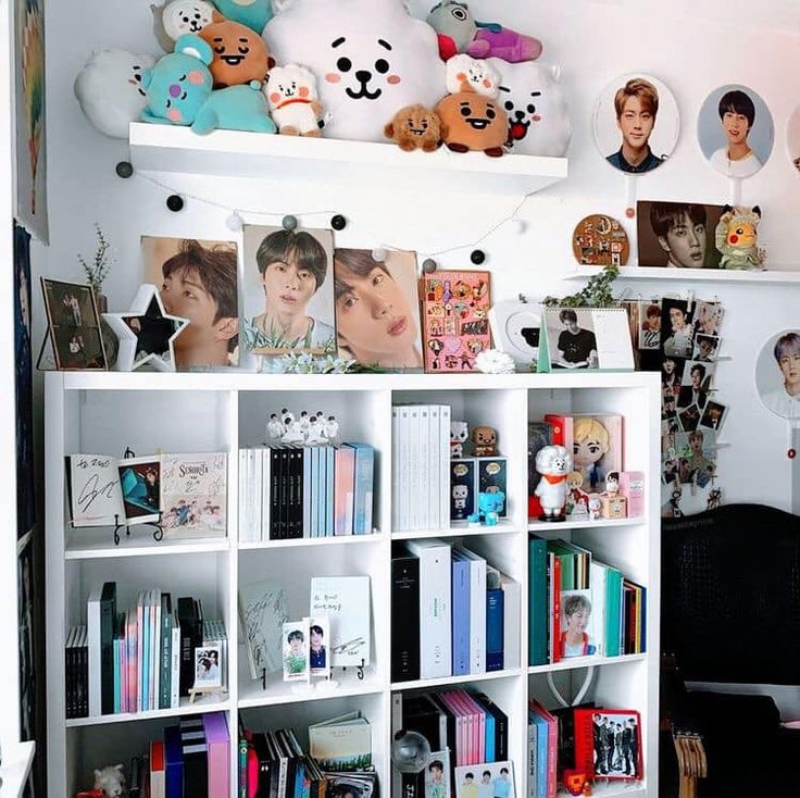 a book shelf filled with lots of books and stuffed animals on top of it's shelves