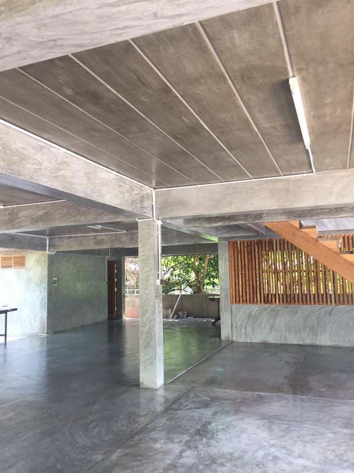 an empty room with concrete floors and stairs