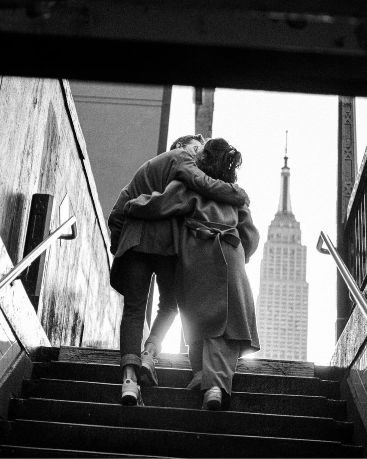 two people are walking up some stairs