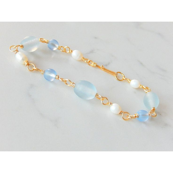 The Blue Glass And Pearl Bracelet Is Composed Of Frosted Glass Beads, White Freshwater Pearls And Gold Non-Tarnish Copper Wire. It Measures 7.5" And Has A Handmade Hook Closure. Elegant Blue Jewelry For Beach, Elegant Blue Glass Bracelets, Elegant Blue Glass Bracelet, Blue Glass Beaded Bracelets For Beach, Blue Jewlery, Jewelry Blue, White Freshwater Pearl, Bracelets Handmade Beaded, Jewelry Diy