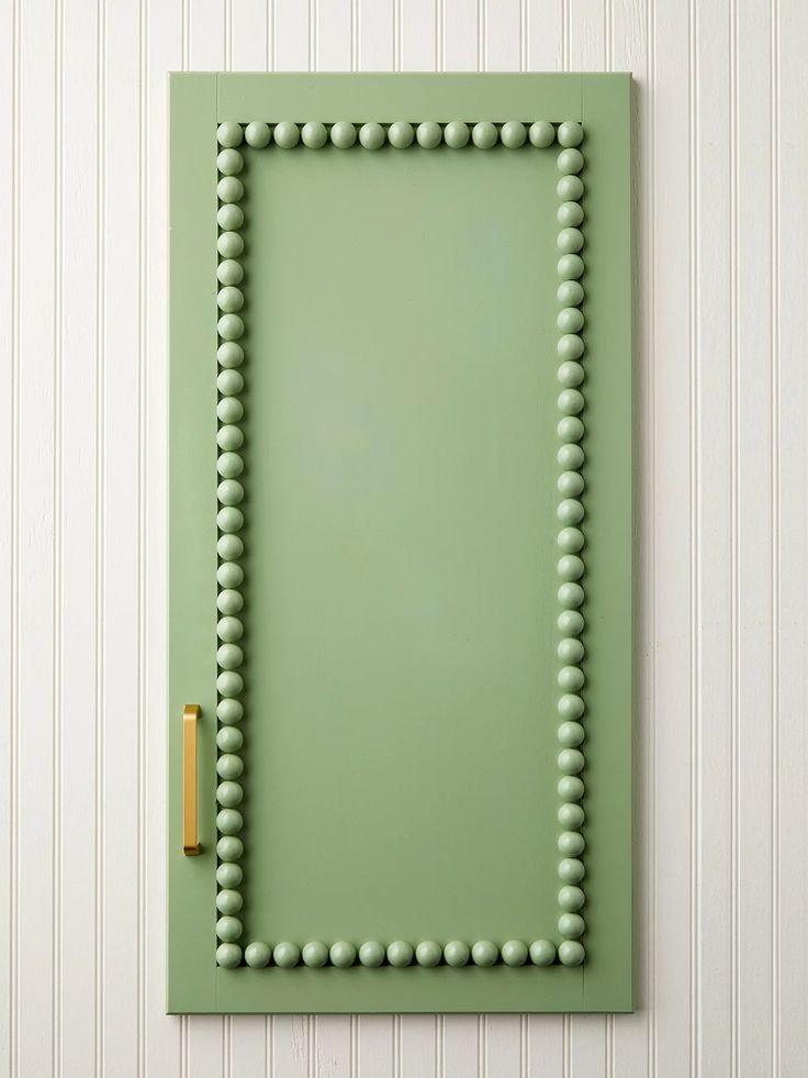 a green door with beaded trim on it