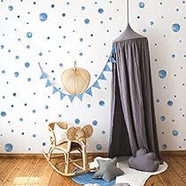 a child's room with blue and white polka dot wallpaper, wooden rocking chair and teddy bear