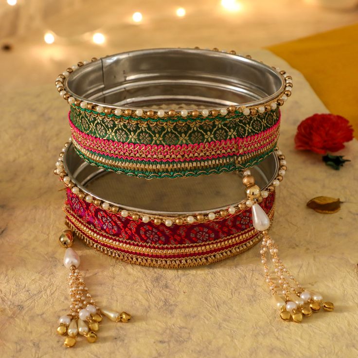 A specially curated Chalni for the auspicious celebration of Karwa Chauth, this Chalni is handmade with pure rawsilk fabric with golden & pearl colored beads that look absolutely elegant. Standard Chalni - 6.5 inches in diameter Gift this Pooja thali along with chalni for your wife who would be keeping a fast for you on the festive occasion of Karwa Chauth Karva Chauth Chalni Decoration, Navratri Banarasi Silk Sets With Latkans, Elegant Multicolor Embroidered Traditional Wear, Gold Brocade Sets For Festivals, Festive Gold Brocade Set, Gold Raw Silk Sets For Festivals, Traditional Gold Embroidered Set, Gold Sets For Traditional Ceremonies With Traditional Drape, Festive Art Silk Traditional Wear With Gota Work