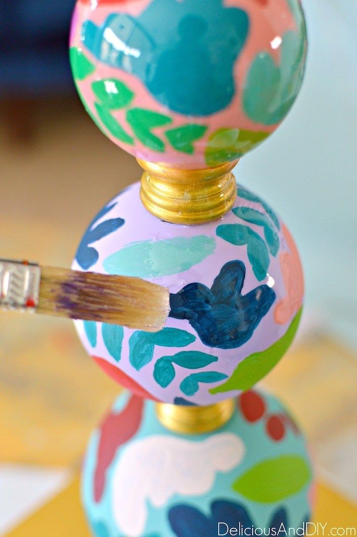 a colorful painted ball with a brush sticking out of it's top and bottom