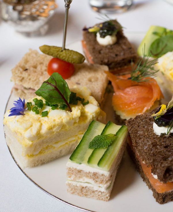 a white plate topped with lots of different types of food on top of a table