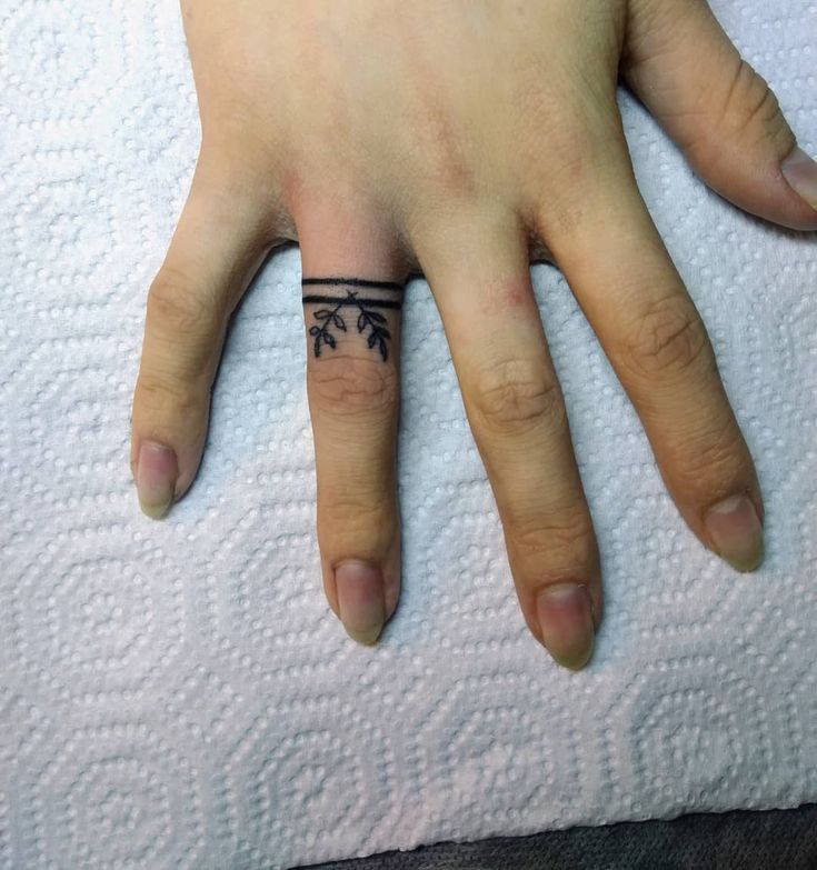 a person's hand with a small tattoo on it