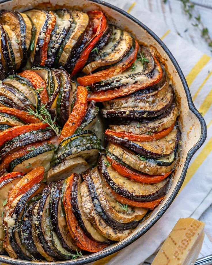 a dish filled with sliced up vegetables on top of a table