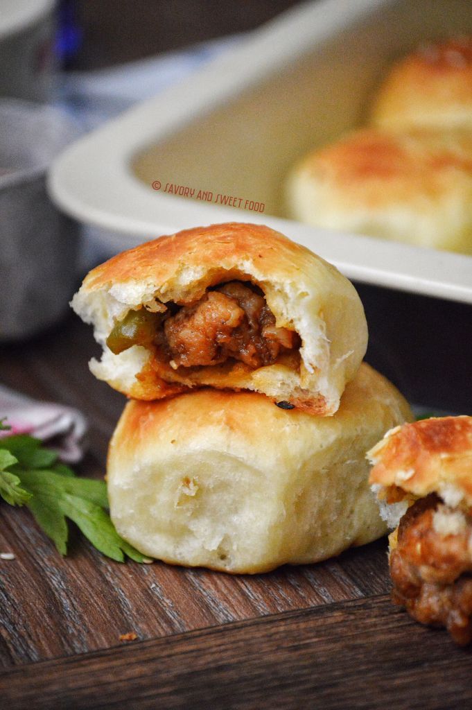 two meatball rolls stacked on top of each other in front of a baking dish