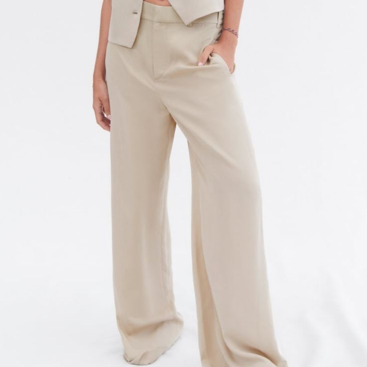 Side Pockets And False Back Welt Pocket. Wide Leg. Front Zip, Button, And Metal Hook Closure. Taupe Brown | Summer Business Casual Pants With Buttons, Business Casual Summer Pants With Buttons, Summer Straight Pants With Button Closure, Summer Wide Leg Pants For Work With Button Closure, Beige Summer Pants With Buttons, Summer Beige Pants With Buttons, Summer Wide Leg Pants With Button Closure, Tailored Wide Leg Pants With Button Closure, Beige Wide-leg Pantsuit For Office