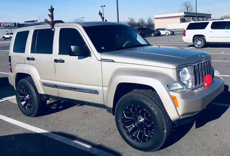 a white jeep parked in a parking lot